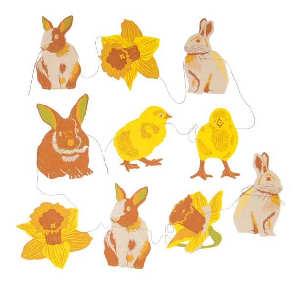 Paper garland of bunnies, daffodils and little yellow chicks connected by a delicate thread.