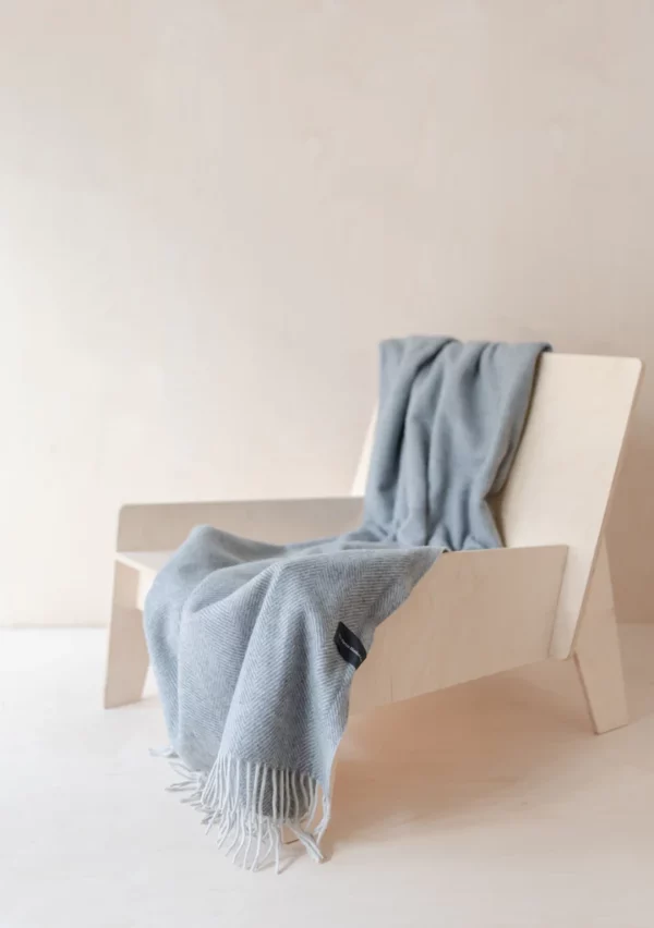 Charcoal wool blanket draped over a chair