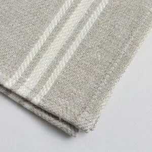 Beige woven fabric with a subtle herringbone pattern and two parallel white stripes, folded neatly on a white surface.