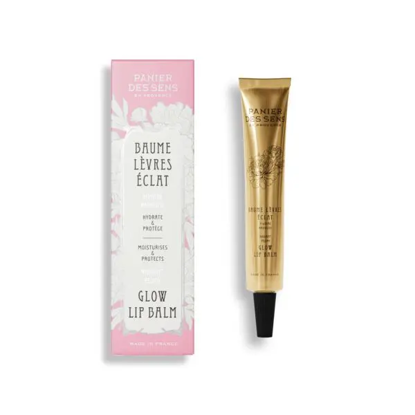 A gold-colored tube of lip balm is displayed next to a decorative box. The tube features elegant floral designs and text indicating it is a "Glow Lip Balm" with moisturizing properties. The box, primarily white with pink accents, highlights the product's benefits, including hydration and protection, and mentions "Radiant Peony." Both items are set against a plain white background.