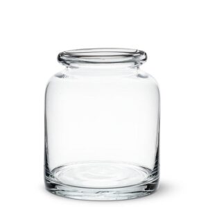 A clear glass jar with a wide mouth and a slightly curved body. The jar has a smooth, polished surface and a flat base, making it stable when placed on a surface. The opening is rimmed, allowing for easy access to its interior. The jar is empty, showcasing its transparent design.