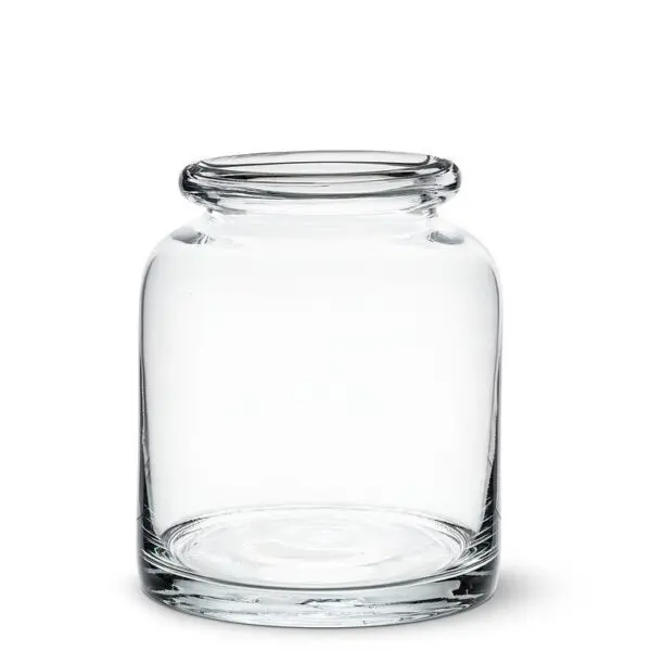 A clear glass jar with a wide mouth and a slightly curved body. The jar has a smooth, polished surface and a flat base, making it stable when placed on a surface. The opening is rimmed, allowing for easy access to its interior. The jar is empty, showcasing its transparent design.