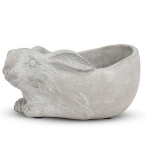 A decorative planter shaped like a rabbit, crafted from a light gray material. The planter features detailed textures, including the rabbit's fur and facial features, with its ears positioned back. The hollow interior is designed for holding plants or flowers, while the base is slightly rounded for stability.