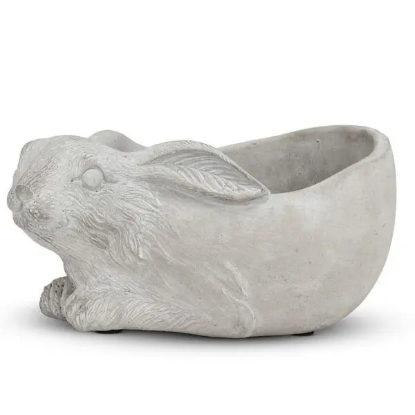 A decorative planter shaped like a rabbit, crafted from a light gray material. The planter features detailed textures, including the rabbit's fur and facial features, with its ears positioned back. The hollow interior is designed for holding plants or flowers, while the base is slightly rounded for stability.