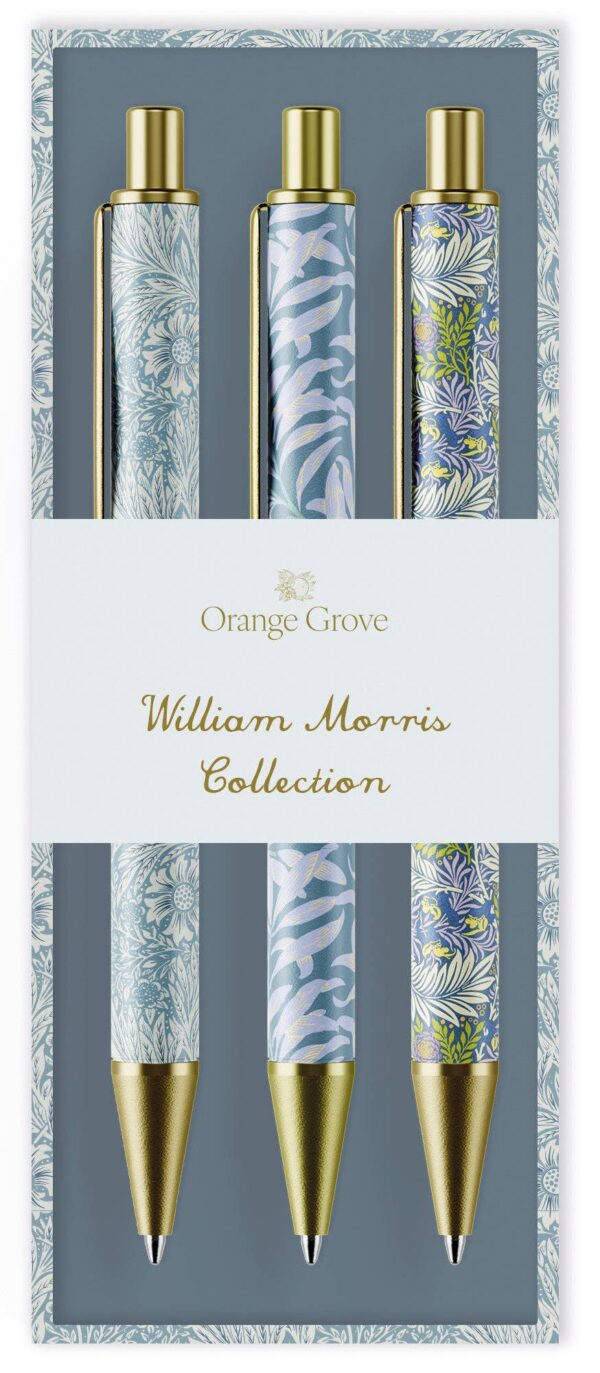 A set of four decorative pens is displayed in a neatly designed box. Each pen features a unique floral pattern inspired by William Morris, with colors ranging from soft blues to vibrant greens and purples. The pens have gold accents at the top and a pointed tip. The packaging includes a label that reads "Orange Grove" and "William Morris Collection," set against a muted blue background. The overall aesthetic is elegant and artistic, reflecting a classic design style.