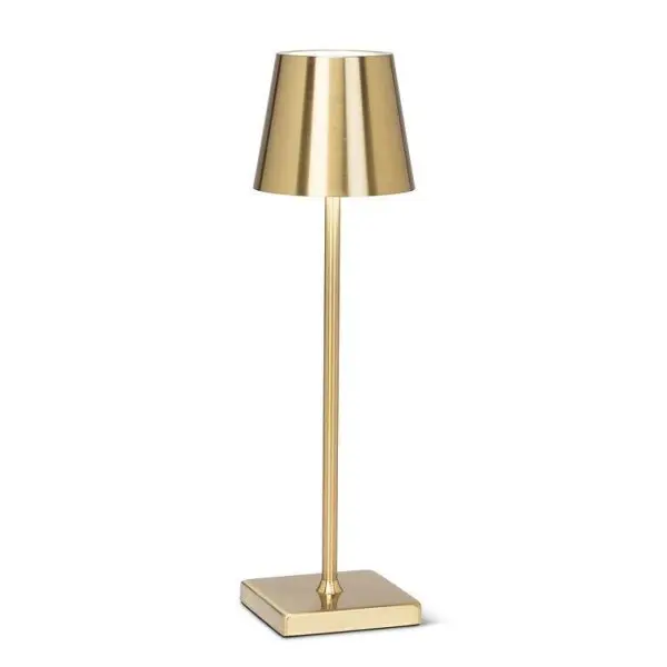 A sleek, modern table lamp with a metallic gold finish. The lamp features a cylindrical shade that tapers towards the top, sitting atop a slender, straight stem. The base is square and also finished in gold, providing stability and a contemporary aesthetic. The overall design is minimalist and elegant, suitable for various interior styles.