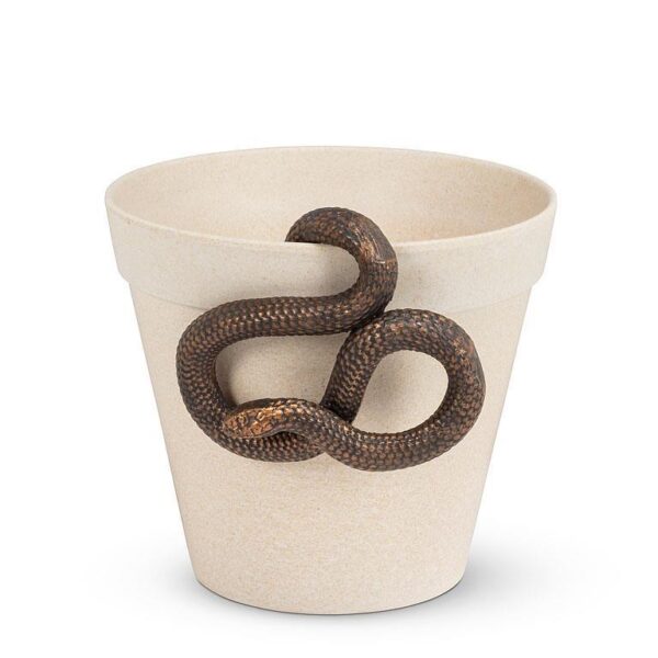 A light-colored, textured flower pot is shown, with a snake coiled around its rim. The snake has a dark, patterned body, contrasting with the pot's neutral tone. The overall composition highlights the unusual pairing of the snake and the pot, creating an intriguing visual.