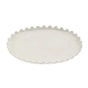 A round, white ceramic plate with a scalloped edge. The surface is smooth and glossy, reflecting light subtly. The design is simple yet elegant, suitable for serving or displaying food.