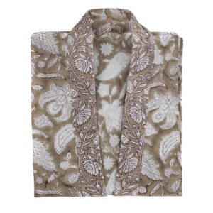 A folded garment featuring a floral and leaf pattern in white on a light brown background. The design includes intricate details of flowers and leaves, creating a textured appearance. The garment has an open front, suggesting it may be a kimono or similar style. The fabric appears lightweight and suitable for casual wear.