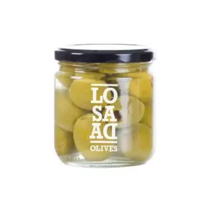A clear glass jar filled with green olives is shown. The jar has a black lid and features a white label with the text "LO SA AD OLIVES" printed on it. The olives are submerged in brine, and some are partially visible through the glass.