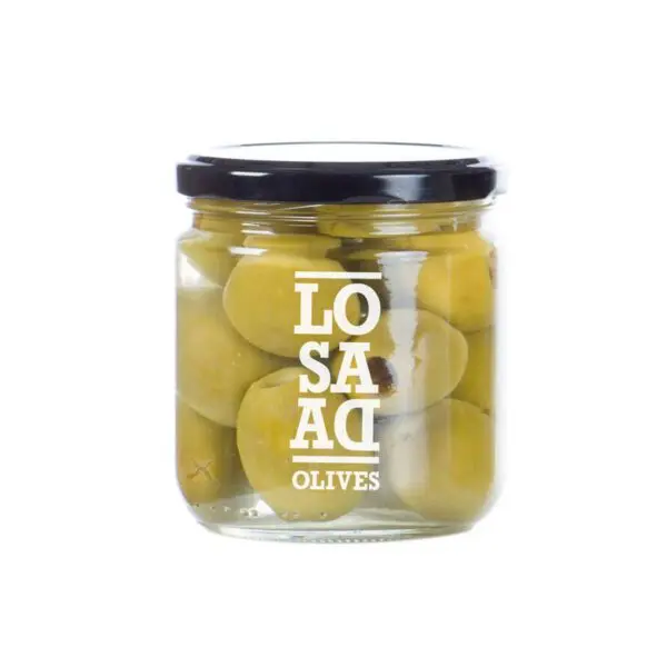 A clear glass jar filled with green olives is shown. The jar has a black lid and features a white label with the text "LO SA AD OLIVES" printed on it. The olives are submerged in brine, and some are partially visible through the glass.